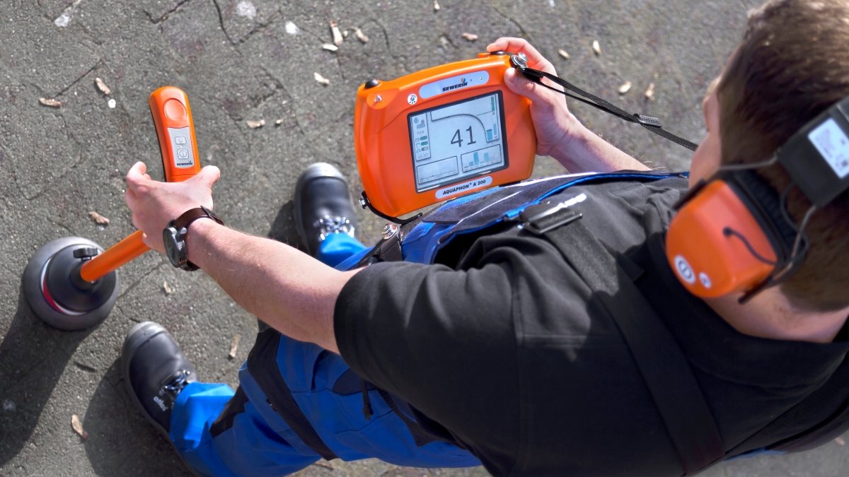 Simeone Plumbing technician using acoustic leak detection equipment to find a hidden water leak